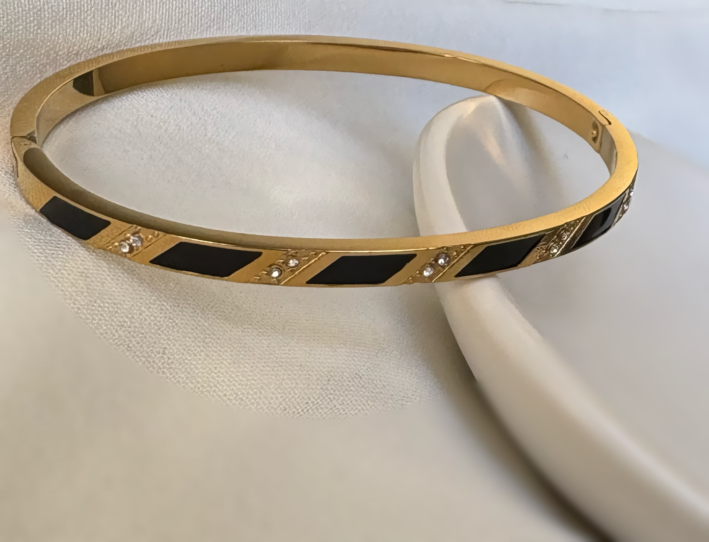 A Stylish Gold and Black Enamel Bracelet with Diamond Details